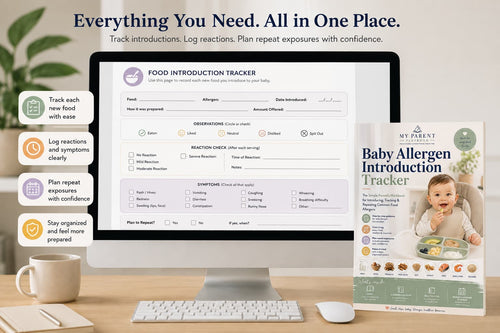A desktop monitor and a printed Baby Allergen Introduction Tracker card are shown on a desk with a keyboard, mouse, mug, and decorative plants. The screen displays a food introduction tracker interface, and the card features a baby photo and the text 'My Parent's Baby Allergen Introduction Tracker.